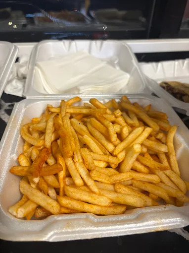 Crispy seasoned fries in a takeout container