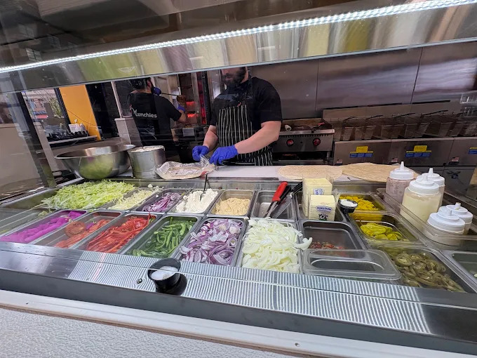 Fresh toppings and vegetables behind the counter